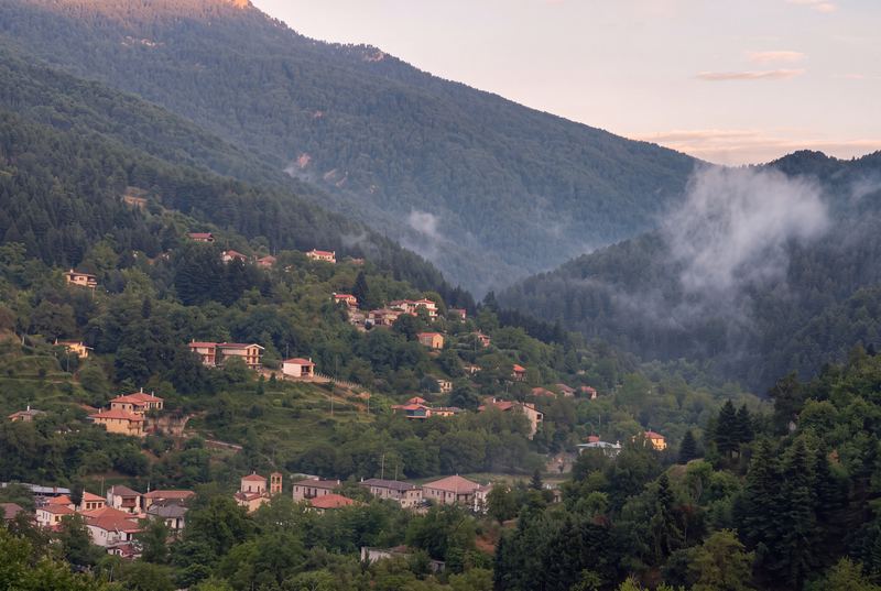 Χωριό στην πλαγιά με ομίχλη στην κοιλάδα